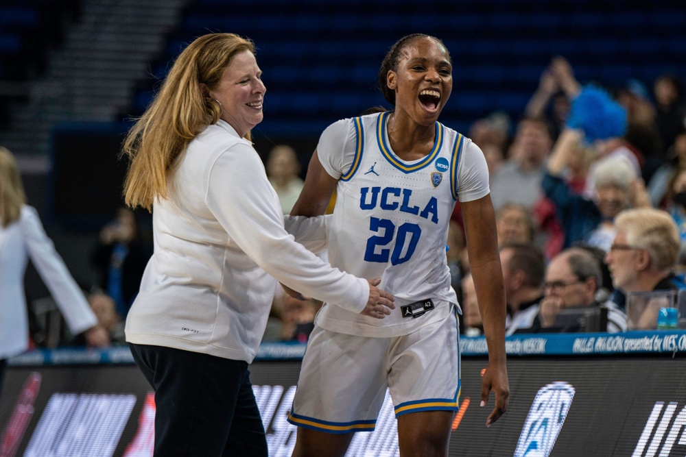 UCLA Bruins guard Charisma Osborne (20) celebrates with head coach Cori Close during a NCAA women’s basketball tournament game against the Oklahoma So - Image ID: 2PGAA34